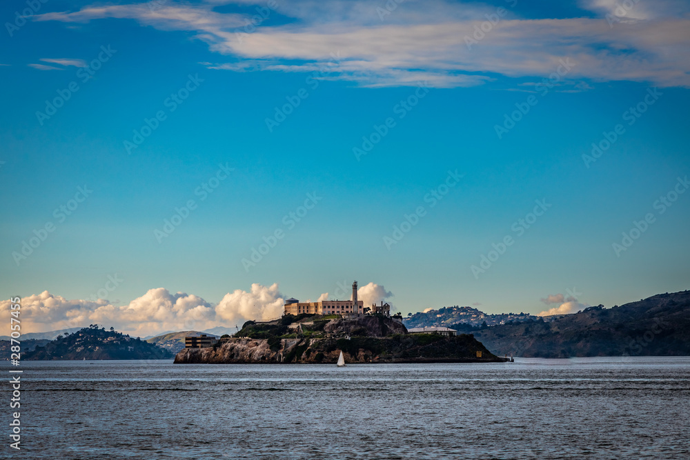 Alcatraz with blue sky and a sailboat
