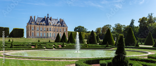 Panoramic view of Parc and chateau de Sceaux with a fountain in foreground - Hauts-de-Seine, France.