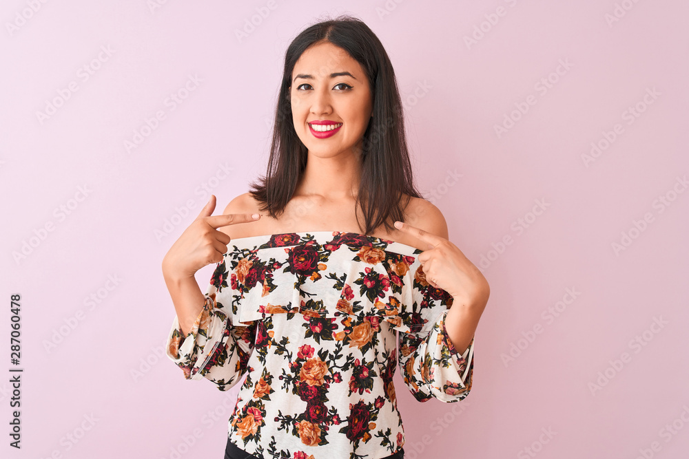 Young chinese woman wearing floral t-shirt standing over isolated pink background looking confident with smile on face, pointing oneself with fingers proud and happy. Young chinese woman wearing floral t-shirt standing over isolated pink background looking confident with smile on face, pointing oneself with fingers proud and happy.