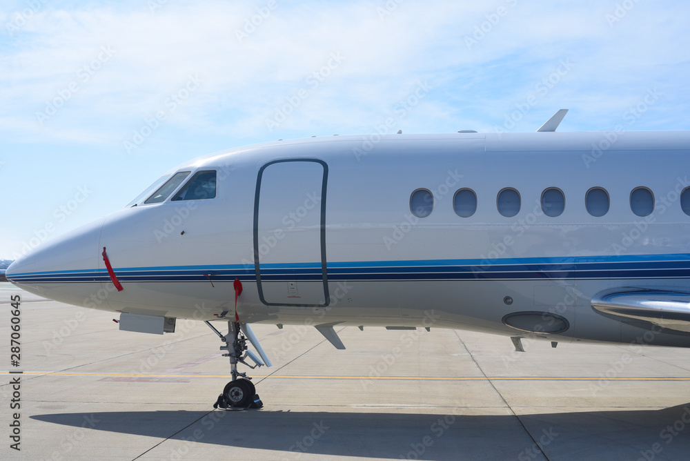 Side of a parked white corporate jet.