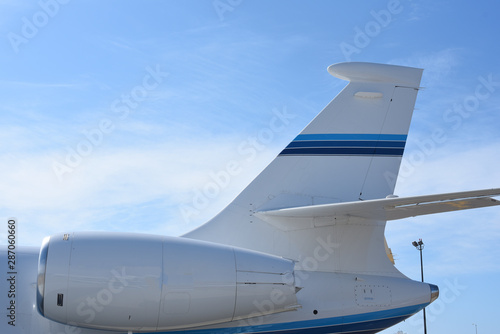Close up of jet engine and tail of a private jet.