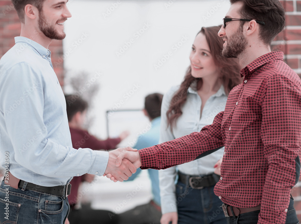 Closeup image of business partners making handshake in an office Closeup image of business partners making handshake in an office