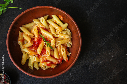 pasta penne and tomato sauce - delicious second course, menu concept. food background. copy space