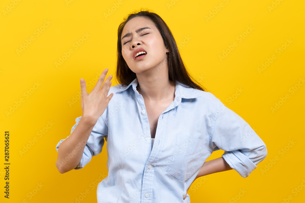 Face expression of human. Asian beautiful female expression feeling hot weather in the summer day in studio shoot yellow background. Face expression of human. Asian beautiful female expression feeling hot weather in the summer day in studio shoot yellow background.