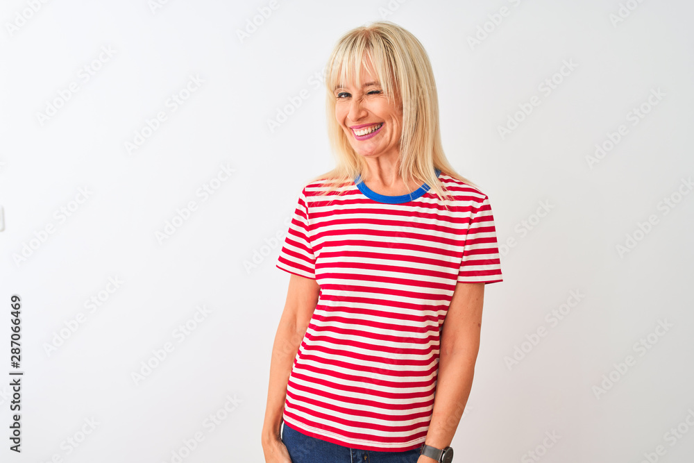 Middle age woman wearing casual striped t-shirt standing over isolated white background winking looking at the camera with sexy expression, cheerful and happy face. Middle age woman wearing casual striped t-shirt standing over isolated white background winking looking at the camera with sexy expression, cheerful and happy face.