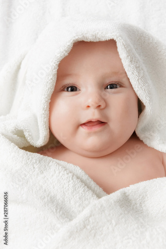 Smiling baby in a towel