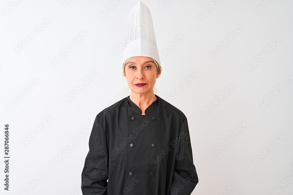 Middle age chef woman wearing uniform and hat standing over isolated white background with serious expression on face. Simple and natural looking at the camera. Middle age chef woman wearing uniform and hat standing over isolated white background with serious expression on face. Simple and natural looking at the camera.