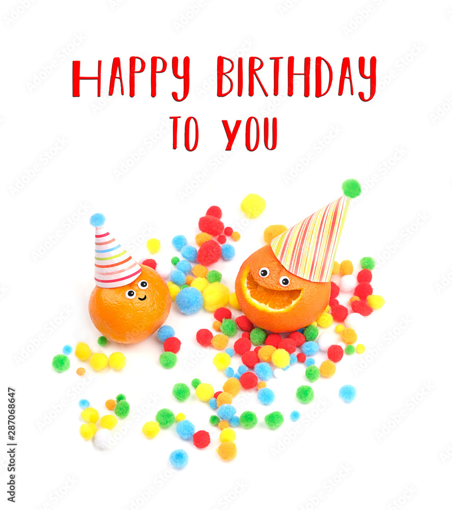 Obraz premium Happy birthday to You. greeting card with two funny oranges in festive hat. creative idea of cheerful fresh fruit. funny fruit. Tangerines with smile and colorful confetti on white background.