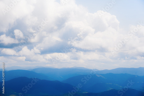 Beautiful mountains on the background of cloudy blue sky. © Андрей Репетий