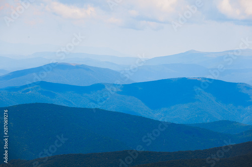 Mountain landscape of blue hills on the background of cloudy sky