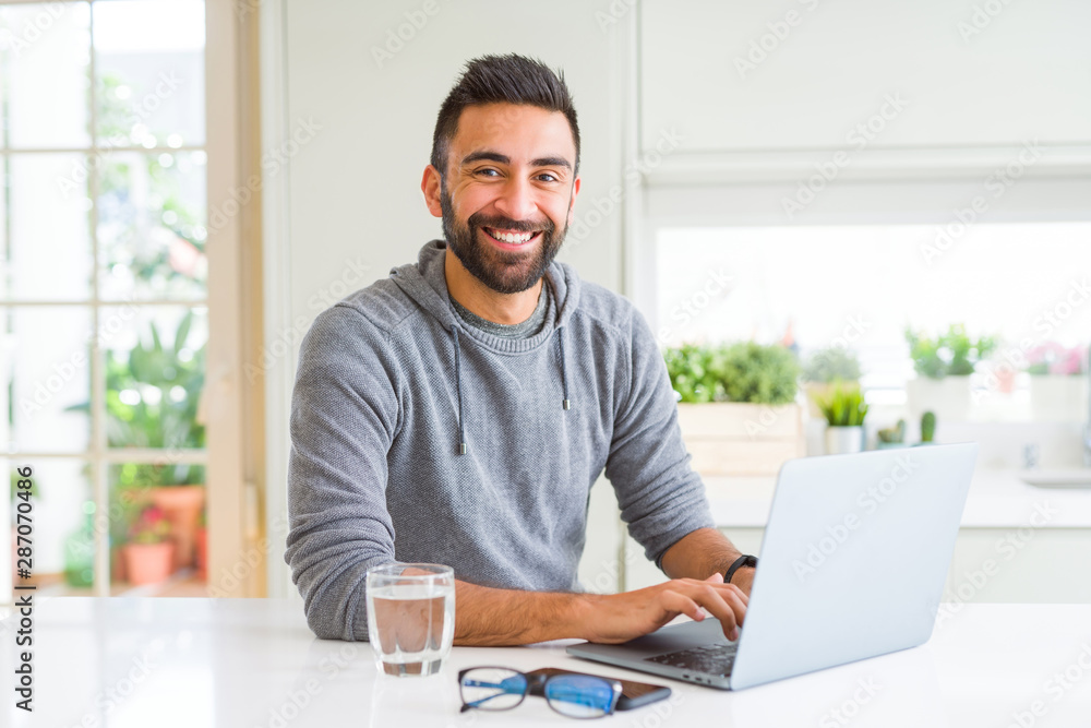 Fototapeta premium Man smiling working using computer laptop