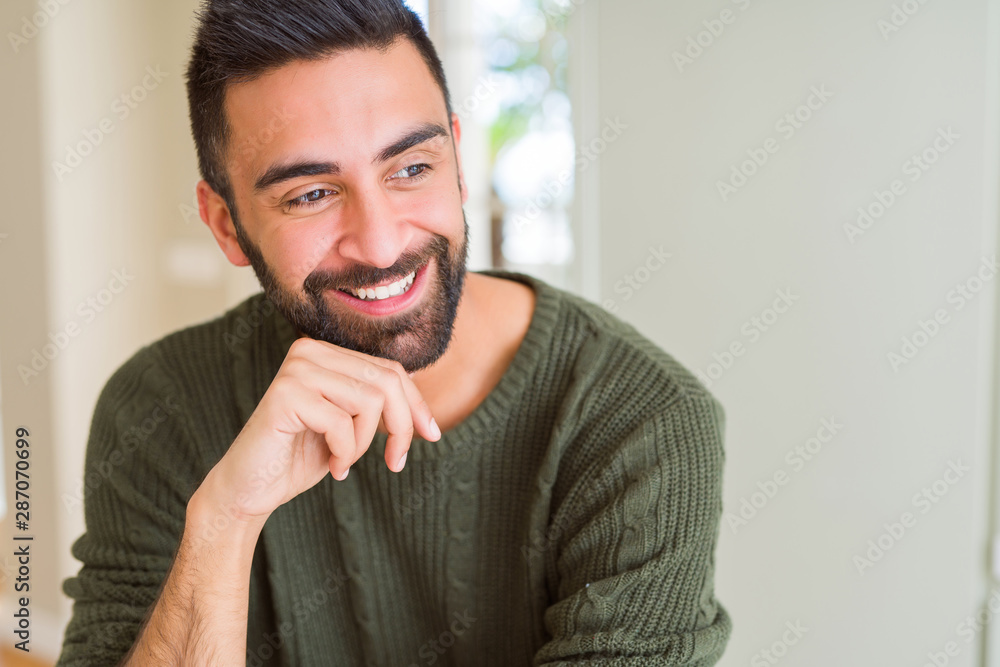Plakat Handsome man thinking confused about doubt, questioning an idea smiling happy