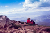 woman sits and looking afar to mountains