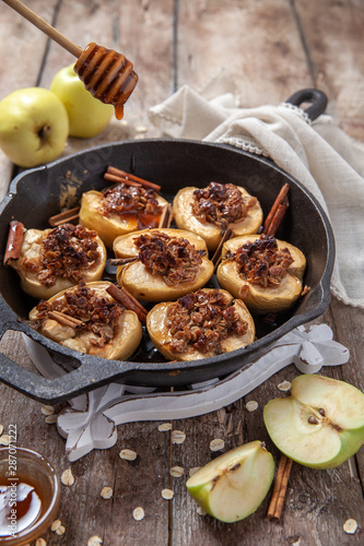 Baked apple with pecan nuts, honey and oat flakes