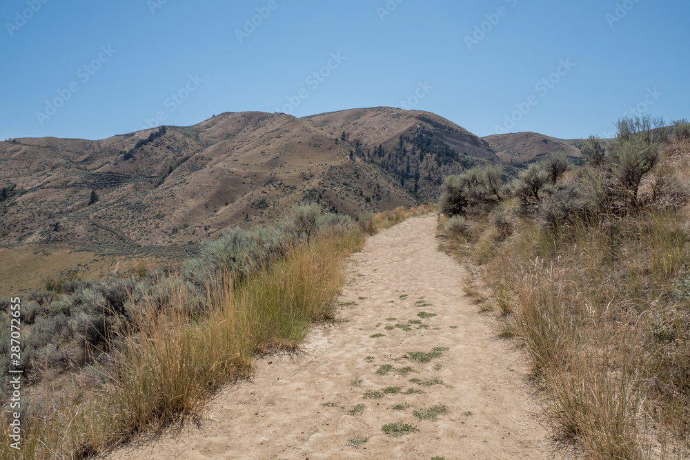 desert trail leading to Saddle Rock foothills in Wenatchee Washington desert trail leading to Saddle Rock foothills in Wenatchee Washington