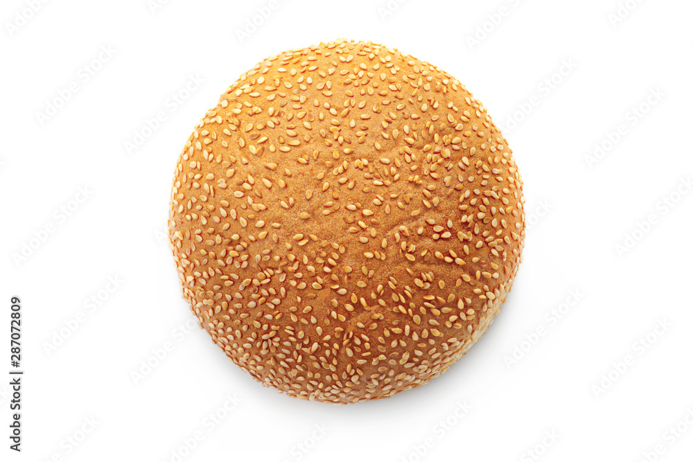 Flat lay round bun with sesame seeds for hamburger isolated on a white background. Top view of a fresh baked ruddy bun Flat lay round bun with sesame seeds for hamburger isolated on a white background. Top view of a fresh baked ruddy bun