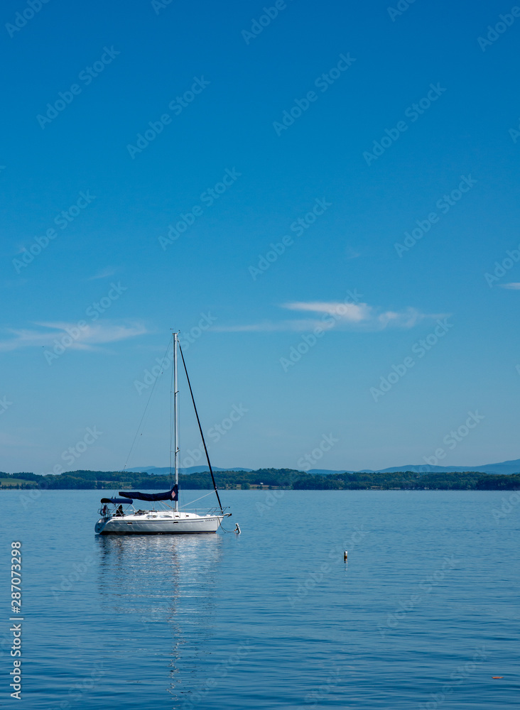 lone sailboat moored in a bay