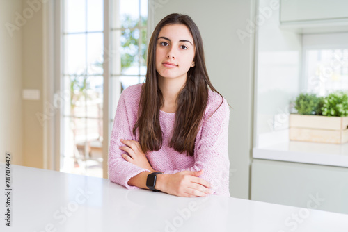 Free Download Beautiful young woman wearing pink sweater Relaxed with serious expression on face. Simple and natural looking at the camera. - GFXLoad