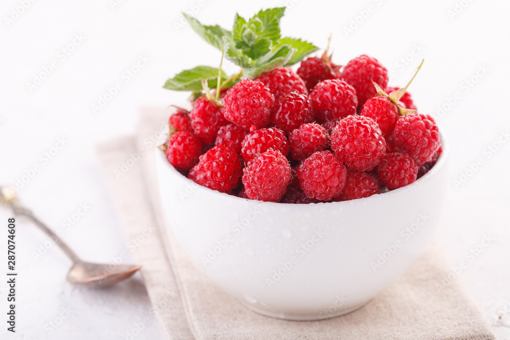 fresh raspberries with mint in a white Cup fresh raspberries with mint in a white Cup
