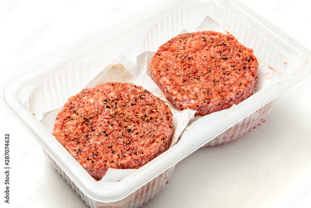 Fresh Organic Angus beef burger patties from above on white background Fresh Organic Angus beef burger patties from above on white background