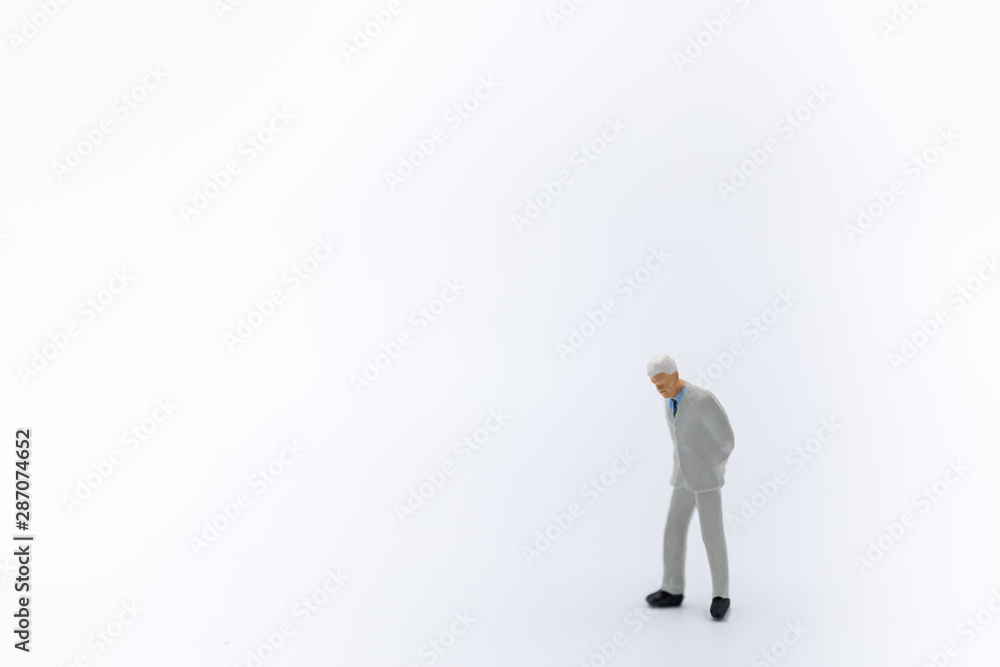 Close up of business,am miniature figure standing and walking on white background with copy space for text. Close up of business,am miniature figure standing and walking on white background with copy space for text.