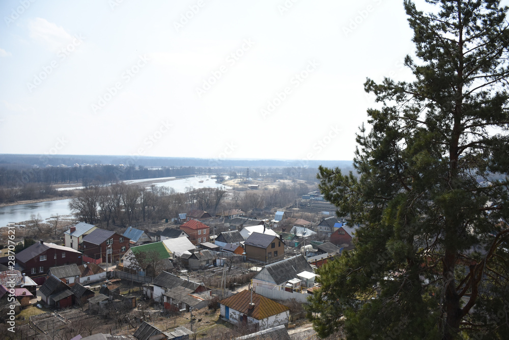 spring landscape view of the village and the river from the hill