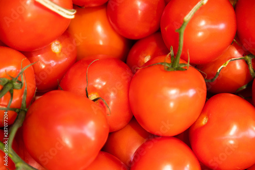 Red juicy meaty pile of glazed tomatoes close-up, vegetable background, salad ingredient