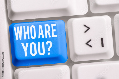 Text sign showing Who Are You question. Business photo showcasing asking demonstrating identity or demonstratingal information White pc keyboard with empty note paper above white background key copy photo