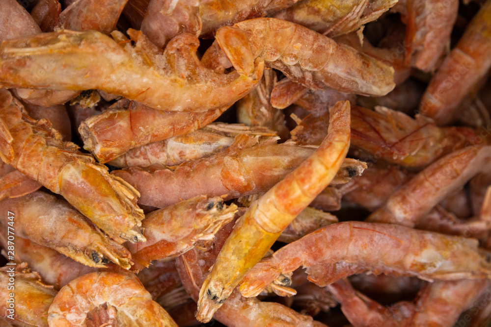 Uncooked gourmet items, open shrimps and prawns on background, close-up
