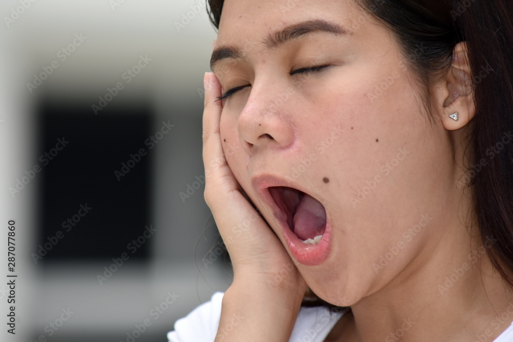 An Attractive Diverse Woman Yawning An Attractive Diverse Woman Yawning