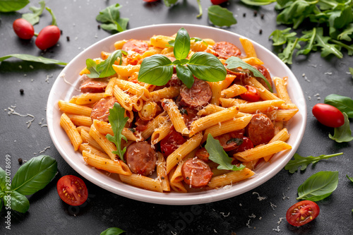 Sausage penne Pasta with tomato sauce and fresh herbs