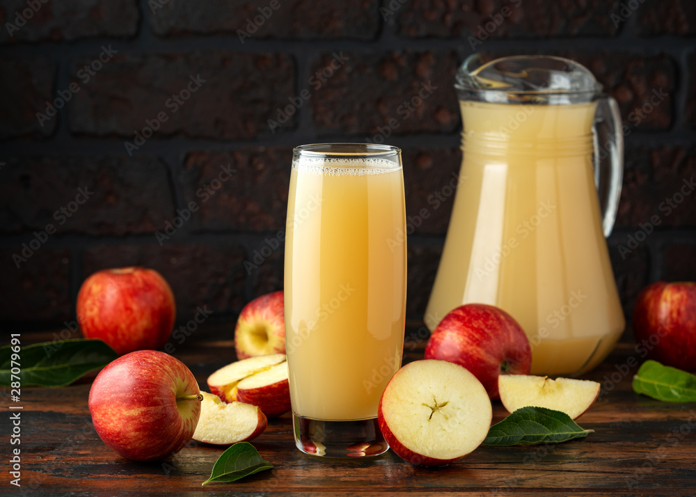 Apple juice in glass on rustic wooden table Apple juice in glass on rustic wooden table