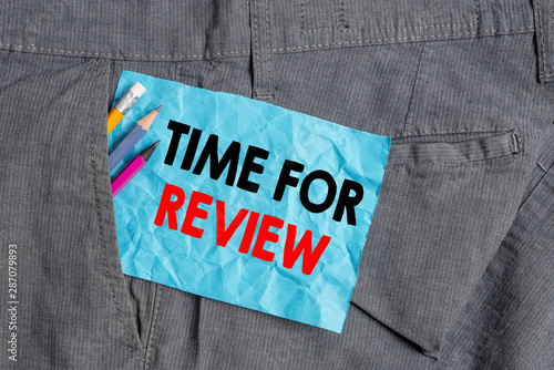 Text sign showing Time For Review. Business photo showcasing review of a system or situation in its formal examination Writing equipment and blue note paper inside pocket of man work trousers