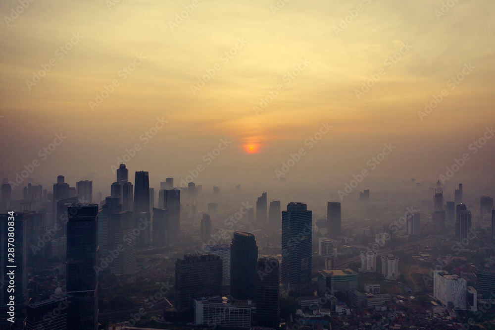 Foggy skyscrapers and residential at dawning