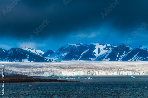 The end of a glacier in the Arctic Circle where it falls into the Arctic Ocean in Hornsund, Svalbard, Norway. photo