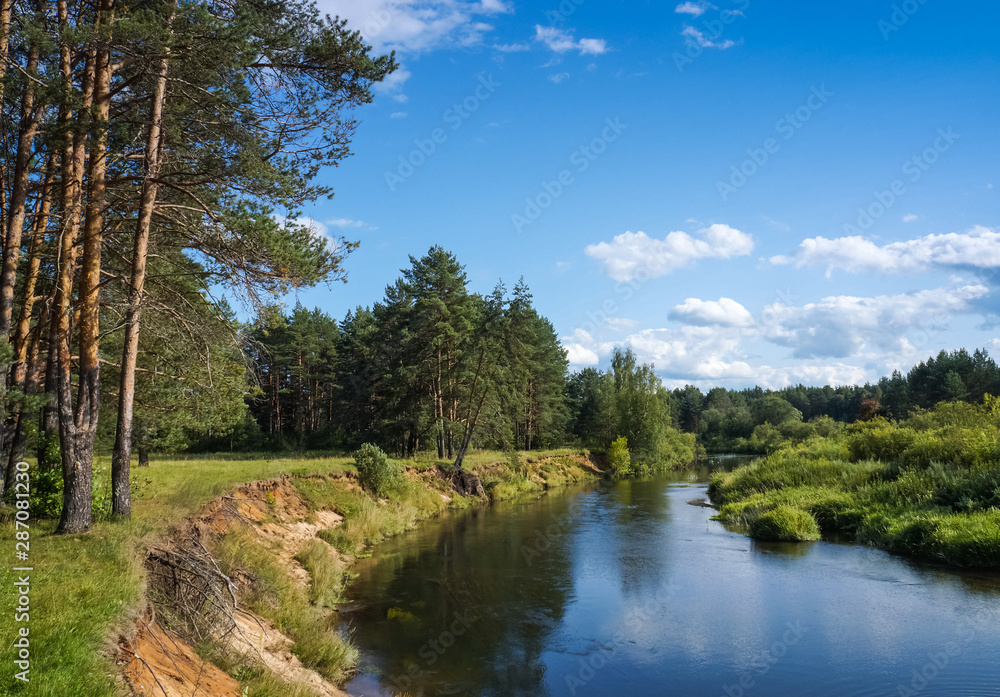 Tranquil summer landscape with a small river flowing through a forest. Nice sunny day in Tver region of Russia Tranquil summer landscape with a small river flowing through a forest. Nice sunny day in Tver region of Russia