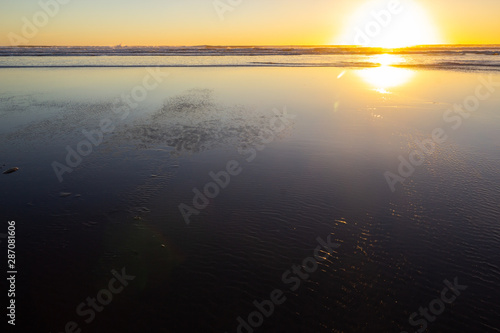 sunset at Piha beach, North Island, New Zealand