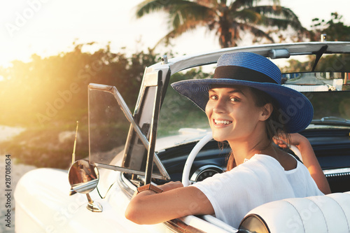 Photography Happy young woman and retro convertible car