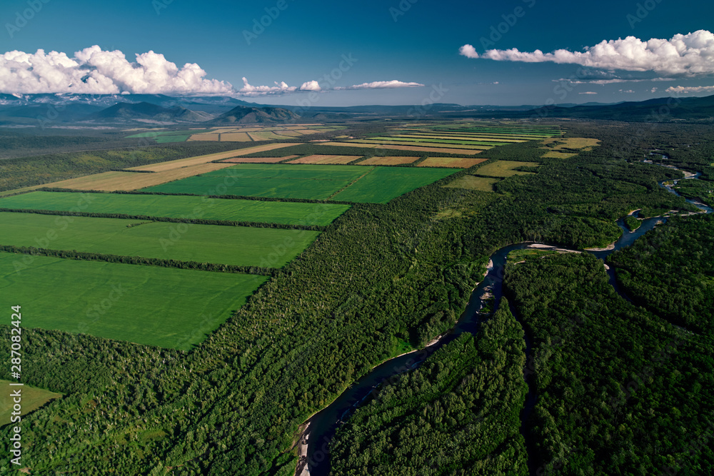 Aerial view of farm fields valley in the Kamchatka in Russia. Agricultural Landscape.