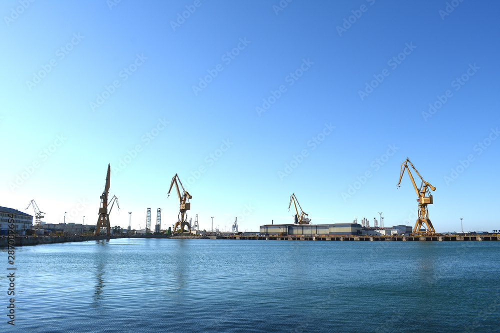 Cranes to repair boats on the coast of the capital city of Cadiz. Andalusia. Spain. Europe.