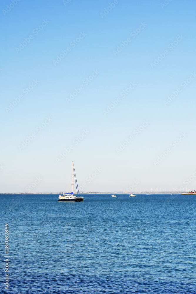 Fishing boats next to the Constitution Bridge, called La Pepa, on the coast of the capital city of Cádiz. Andalusia. Spain. Europe. August 12, 2019