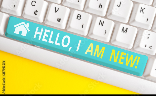 Text sign showing Hello I Am New. Business photo showcasing used as greeting or to begin telephone conversation White pc keyboard with empty note paper above white background key copy space