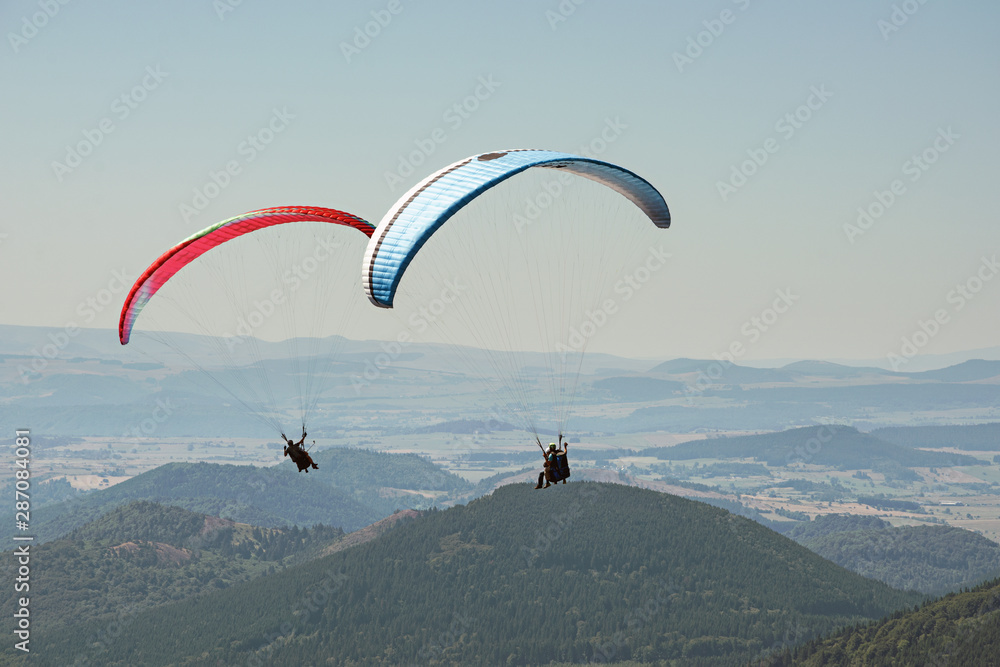Tandem paragliders thermalling in Puy de Dome, Auvergne, French Massif Central. France Tandem paragliders thermalling in Puy de Dome, Auvergne, French Massif Central. France
