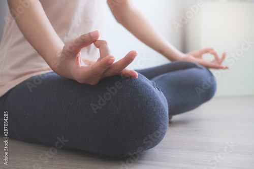 Wallpaper Mural Yoga and meditation lifestyles. close up view of young beautiful woman practicing yoga namaste pose in the living room at home. Torontodigital.ca