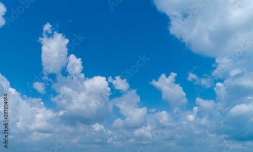 Fototapeta Naklejka Na Ścianę i Meble -  White Clouds Floating in the Bright Blue Skies