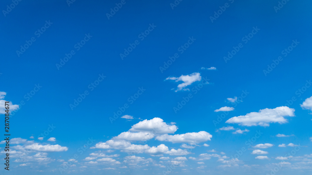 Fototapeta premium White Clouds Floating in the Bright Blue Skies