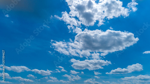 White and Dark Clouds Floating in the Bright Blue Skies © Greg Kelton