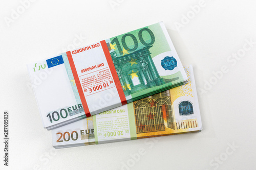 Euro cash in bundles of one hundred and two hundred banknotes, Euro money Euro on a white background, isolated on a white background