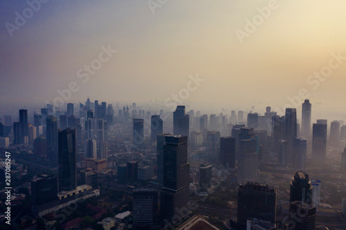 Skyscrapers and residential houses with misty