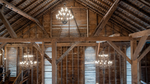 Interior of a Fancy Barn With Chandeliers and Windows
